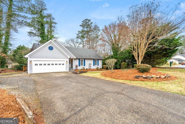 single story home featuring a garage, a shingled roof, and aphalt driveway