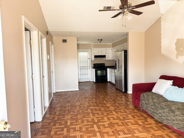 interior space with visible vents, ceiling fan, and baseboards