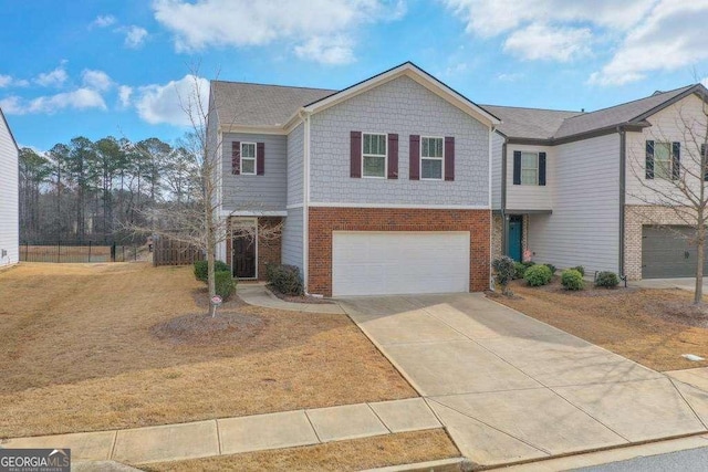 view of front of house with a garage, driveway, brick siding, and a front yard