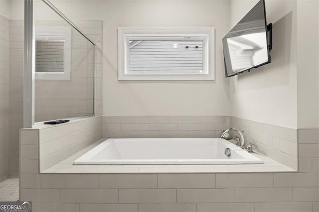 full bathroom featuring tiled shower and a garden tub