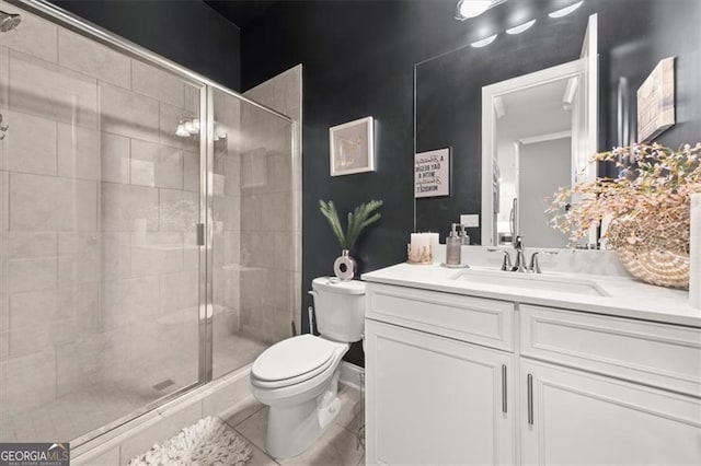 bathroom with a stall shower, vanity, and toilet