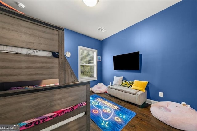 bedroom with dark wood-style floors, baseboards, and visible vents