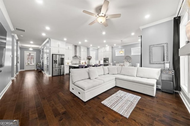 living room featuring ornamental molding, dark wood-type flooring, and recessed lighting