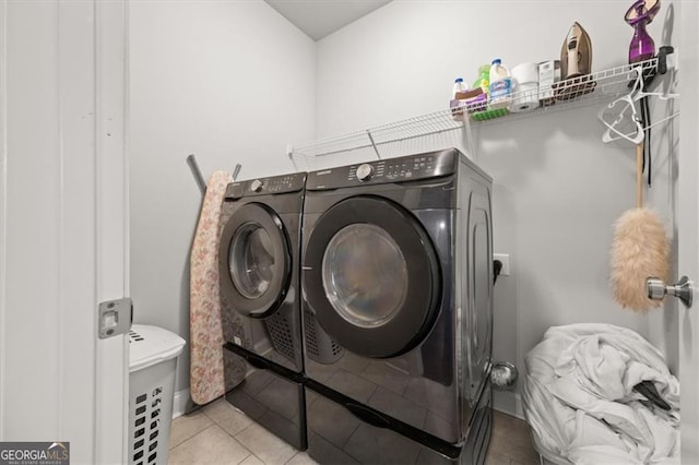 laundry room with laundry area, light tile patterned floors, and separate washer and dryer