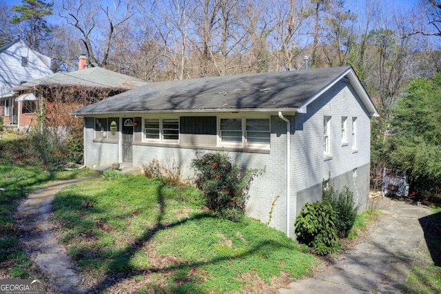 view of home's exterior featuring entry steps and brick siding