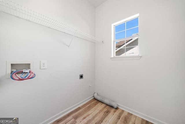 washroom featuring hookup for a washing machine, light wood-style flooring, hookup for an electric dryer, laundry area, and baseboards