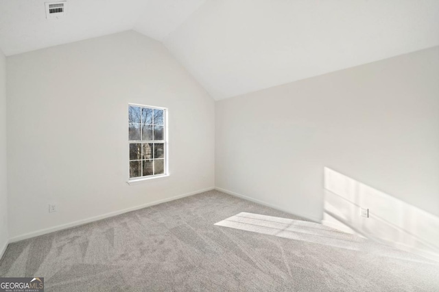 bonus room featuring lofted ceiling, baseboards, visible vents, and light colored carpet