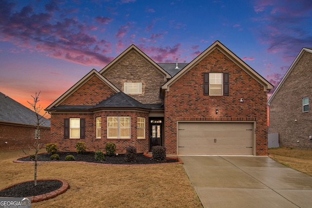 traditional home featuring a yard, concrete driveway, and brick siding