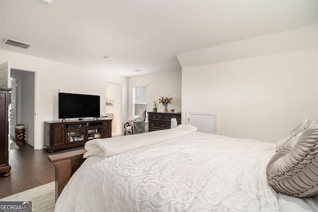 bedroom with dark wood-type flooring and visible vents