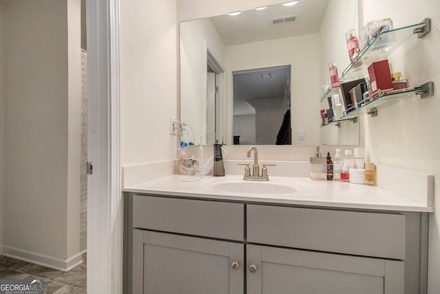 bathroom with visible vents, vanity, and baseboards