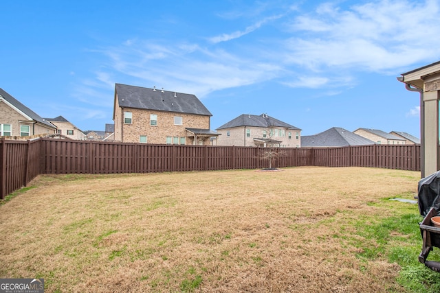 view of yard featuring a residential view and a fenced backyard