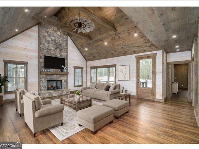 living area with high vaulted ceiling, wood ceiling, a fireplace, and wood finished floors