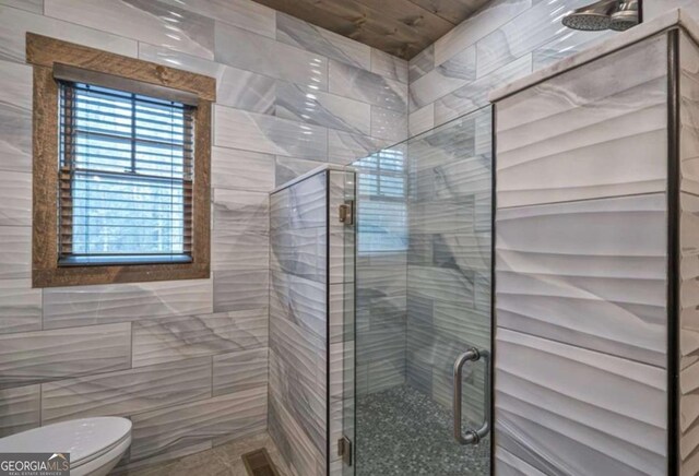 bathroom featuring a stall shower, visible vents, and toilet