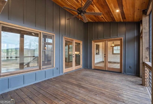 unfurnished sunroom with ceiling fan, french doors, lofted ceiling, and wood ceiling