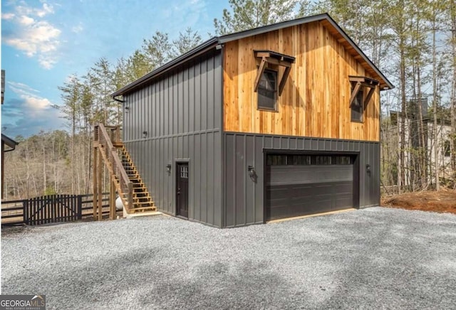 garage featuring a garage and fence