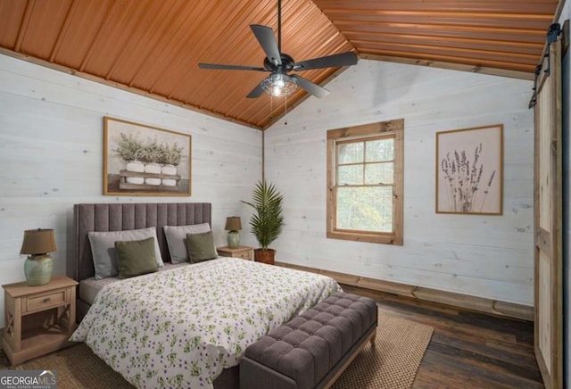 bedroom featuring a barn door, lofted ceiling, wooden ceiling, dark wood-style floors, and wood walls