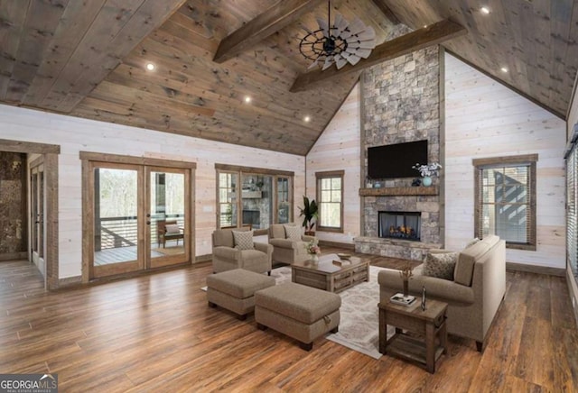 living room featuring wood ceiling, a stone fireplace, beam ceiling, and wood finished floors