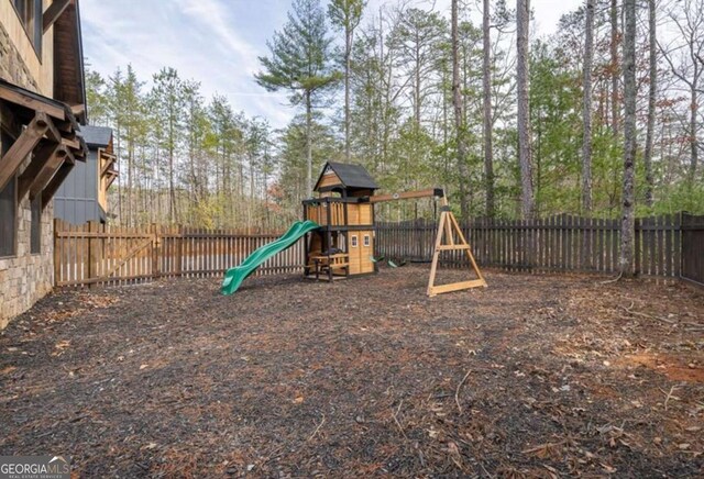 view of playground featuring a fenced backyard