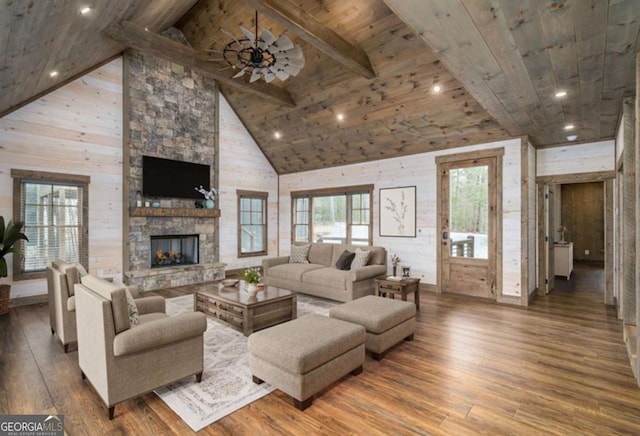 living area with beam ceiling, a fireplace, wood finished floors, high vaulted ceiling, and wooden ceiling