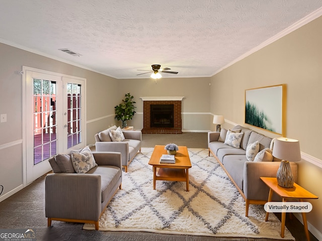 living area featuring crown molding, a fireplace, visible vents, and carpet flooring