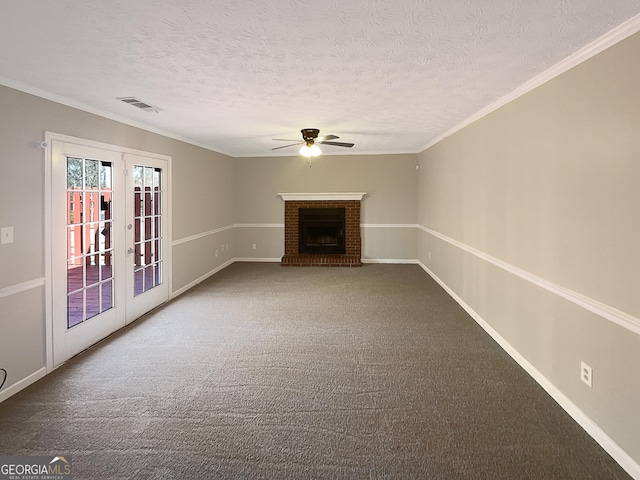 unfurnished living room featuring carpet floors, french doors, a fireplace, visible vents, and a ceiling fan