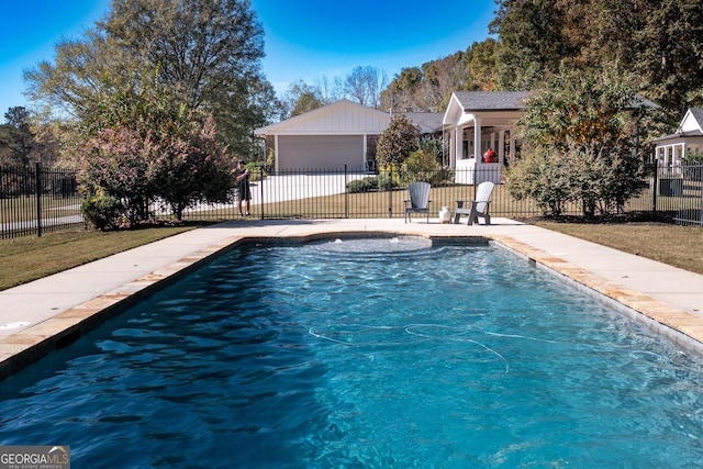 view of swimming pool with a fenced in pool, an outbuilding, fence, and a patio