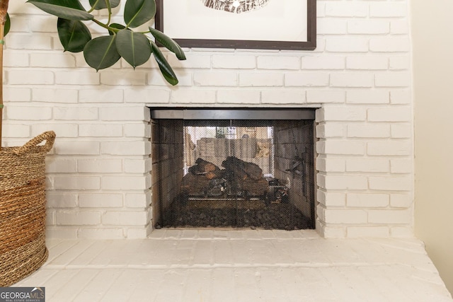 interior details with a brick fireplace