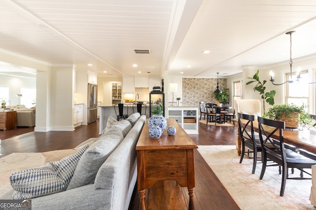 living room featuring visible vents, wood finished floors, crown molding, a chandelier, and recessed lighting