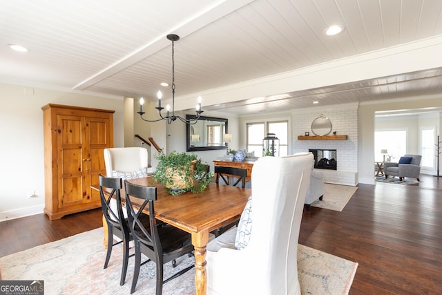 dining area with baseboards, dark wood-style flooring, a brick fireplace, and recessed lighting