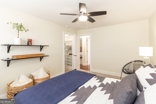 bedroom with light colored carpet, a ceiling fan, and baseboards