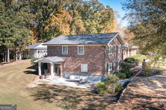 rear view of house featuring a patio area, fence, a lawn, and brick siding