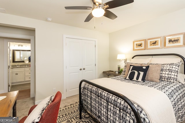 bedroom featuring a closet, light colored carpet, and ceiling fan