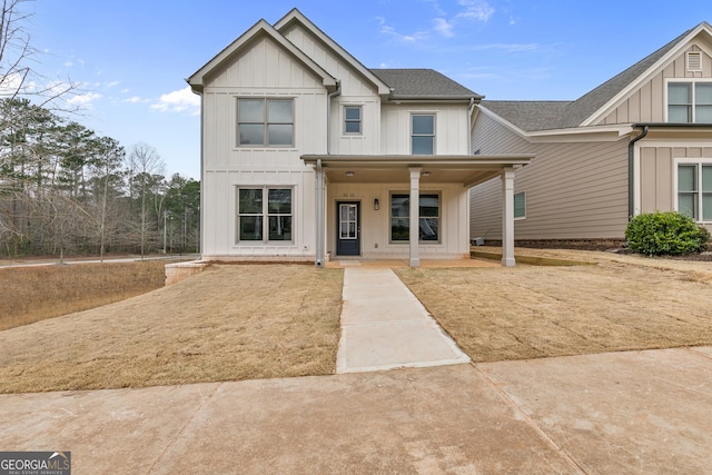 view of front of home with a porch, board and batten siding, and a shingled roof