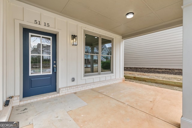 view of exterior entry with board and batten siding