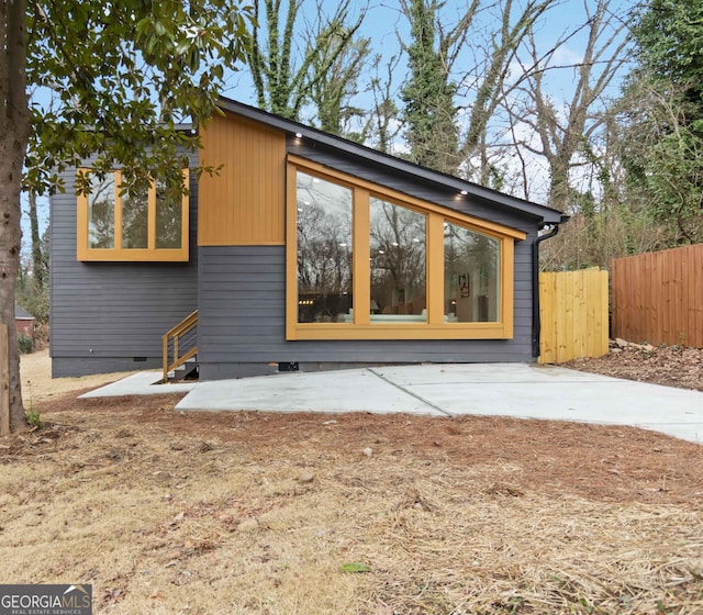 exterior space featuring crawl space and fence