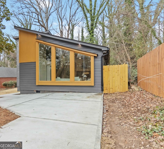 view of outbuilding featuring fence