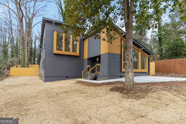 view of front facade featuring crawl space and fence