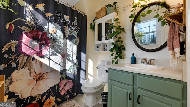 bathroom featuring vanity and toilet