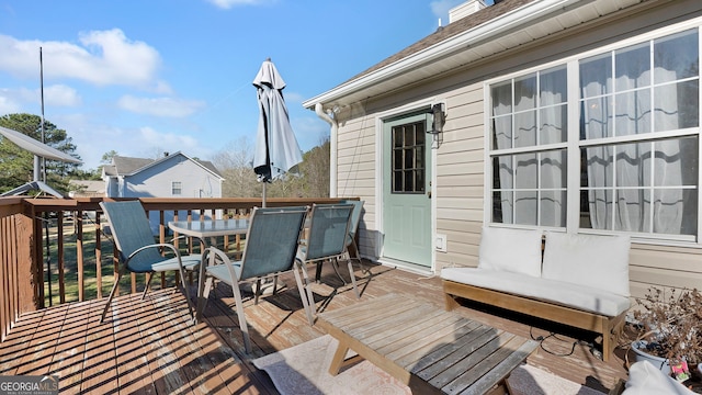 deck with outdoor dining area