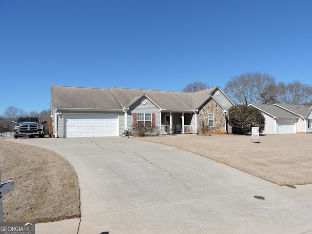 ranch-style home with stone siding, concrete driveway, a porch, and an attached garage