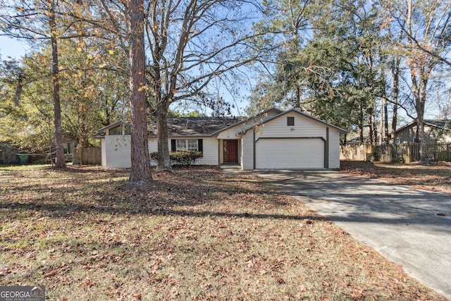 single story home featuring an attached garage, fence, concrete driveway, and brick siding