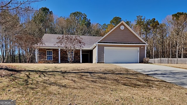 single story home featuring concrete driveway, fence, a garage, stone siding, and a front lawn