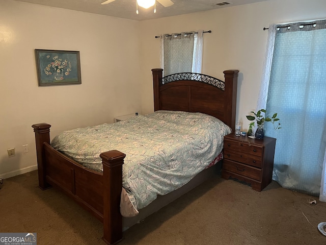 carpeted bedroom featuring ceiling fan and visible vents