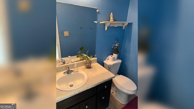 half bath featuring vanity and toilet