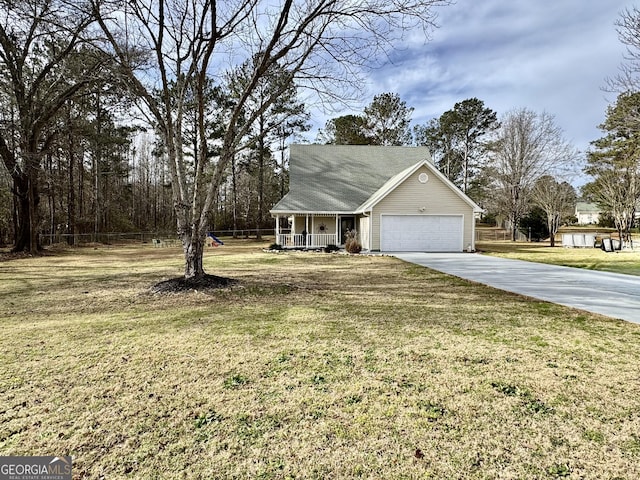 view of front of home featuring an attached garage, covered porch, concrete driveway, and a front yard