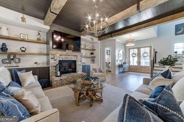 living area with a fireplace, wood ceiling, french doors, beam ceiling, and light wood finished floors