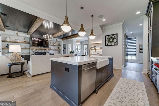 kitchen featuring a sink, open floor plan, hanging light fixtures, a large island, and stainless steel dishwasher