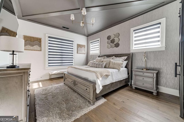 bedroom featuring baseboards, wallpapered walls, visible vents, and light wood-style floors