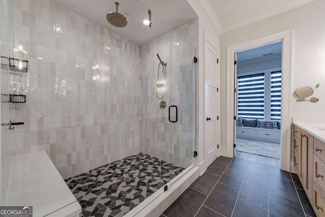 bathroom featuring a stall shower, tile patterned flooring, vanity, and crown molding