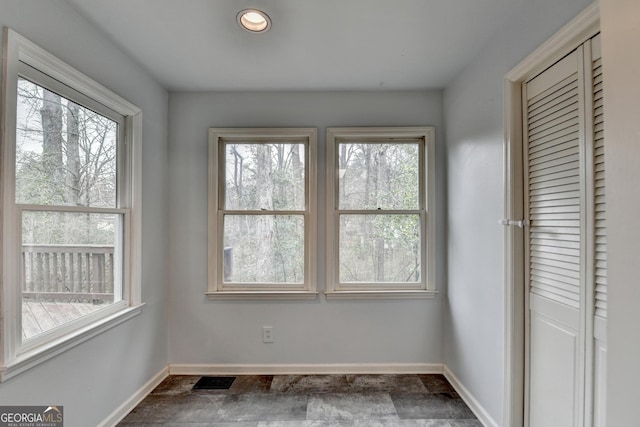 interior space with plenty of natural light and baseboards